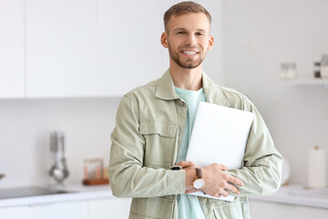 Sticker - Young bearded man with laptop in kitchen