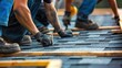© Mnt - Construction workers installing shingles on a rooftop, hands and tools in action, capturing the precision and labor involved in roofing