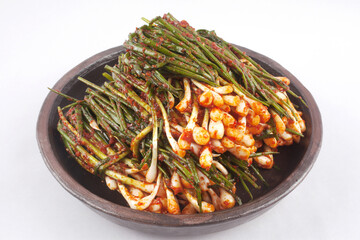 Close-up of Pagimchi(green onion kimchi) with chives and hot pepper paste on pottery, South Korea
