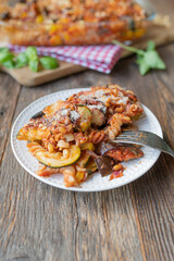 Wall Mural - Vegetarian casserole with ratatouille vegetables, pasta, parmesan cheese and pine nuts