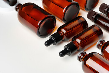 Wall Mural - Mock up of amber glass bottles on white background flat lay