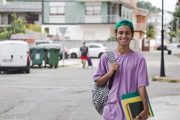 Wall Mural - teenage student with backpack and books on the street