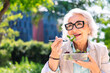 © Raul Mellado - portrait of a middle age woman eating a takeaway salad sitting outdoors in a city park, concept of healthy food and active lifestyle in adulthood, copyspace for text