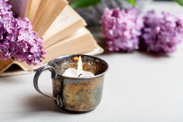 Wall Mural - Candle holder, old book and lilac flower.