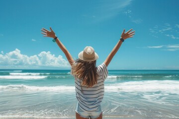 Poster - Young teenager with her arms raised in joy, standing on the beach facing an ocean view under clear blue skies.