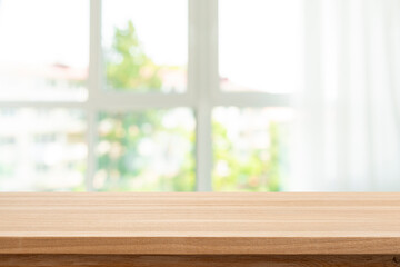 Wall Mural - blank wood table top on blur big window with curtain and abstract view to green town background