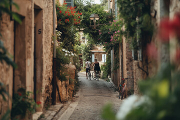 Canvas Print - Couple on a romantic bike ride through a village