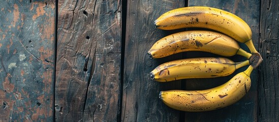 Aufkleber - Bananas that are ripe placed on a wooden backdrop with ample copy space image available