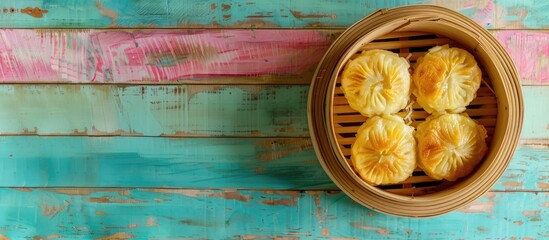 Aufkleber - A bamboo bowl filled with steamed bread topped with coconut jam is placed on a colorful wooden table providing a perfect copy space image from above