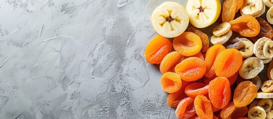 Poster - Assorted dried fruits like bananas apples and apricots arranged for a flat lay view creating a space for text with a copy space image