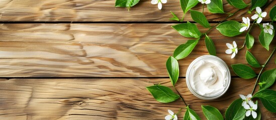Poster - Bright wooden table with white cosmetic cream and leaf buds offers copy space image