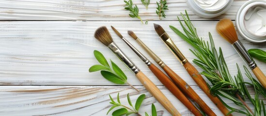 Aufkleber - Top down view of paint brushes herbs painting and a picture on a white wooden background offers ample copy space for customization of images