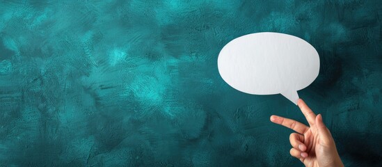 Poster - Close up photo of a hand holding an empty white speech bubble for a text message with a copy space image
