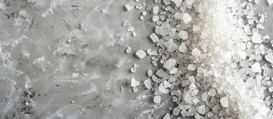 Sticker - Top down view of mineral bath salt on a grey background with ample copy space for text or images