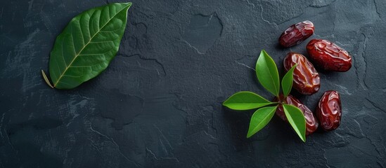Aufkleber - Flat lay composition featuring branches of sweet dried dates a green leaf on a black table ideal for text placement in copy space image