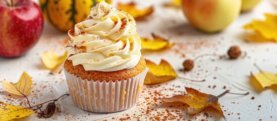 Poster - A broken homemade Apple cupcake with Apple filling on a light background with yellow leaves evokes the essence of fall baking and harvest in the copy space image