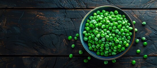 Aufkleber - A bowl of fresh green peas on a dark wooden backdrop from above with room for text or images. Creative banner. Copyspace image