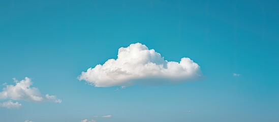 Aufkleber - A cloud against a blue sky creating a serene copy space image