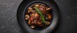 © HN Works - Top down view of duck leg confit with mushroom sauce presented on a black plate against a slate background with ample copy space image