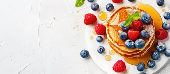 Wall Mural - Delicious American pancakes adorned with raspberries blueberries and honey embodying a breakfast theme complemented by a copy space image