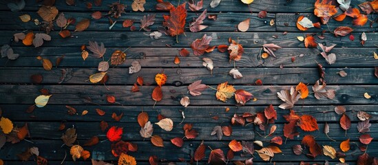 Fototapete - Aerial view of a wooden surface covered with autumn leaves ideal for a copy space image