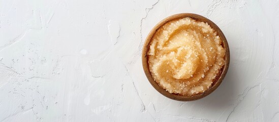 Poster - Top view of a body scrub on a white backdrop offers ample copy space image