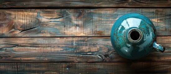 Poster - Top down view of a hot water bottle displayed on a wooden surface with ample copy space image