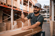 © standret - Showing thumb up. Foreman is in the storehouse, shipping distribution business