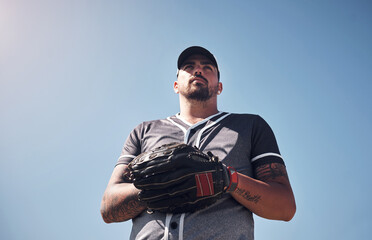 Sticker - Man, sports and baseball outdoor with glove for playing game, exercise or club competition on field. Player, determined and softball athlete in stadium with training, low angle and blue sky for pitch