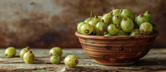 Wall Mural - A clay bowl filled with fresh gooseberries on a wooden table with a rustic background perfect for a copy space image