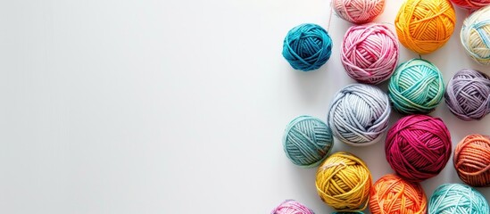 Poster - Colorful yarn balls displayed on a white background with copy space image