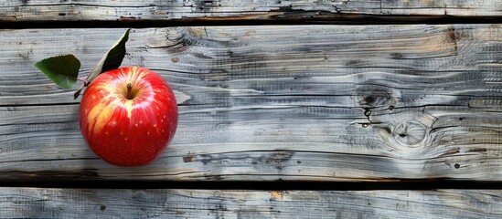 Poster - Apple placed on weathered wooden surface with copy space image available