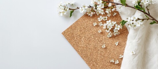 Poster - A cork board on a cotton napkin placed elegantly on a white table to serve as a natural backdrop for showcasing brands with ample copy space for text or product display in the image