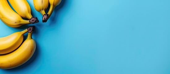 Poster - A blue backdrop with bananas and copy space image