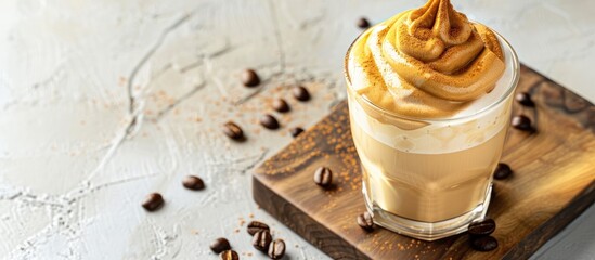 Aufkleber - Close up of Dalgona coffee in a glass on a cutting board a trendy cold drink on a light background offering copy space image for text in a flat lay style