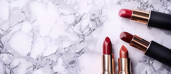 Poster - Cosmetic items such as lipsticks displayed on a marble backdrop with copy space image
