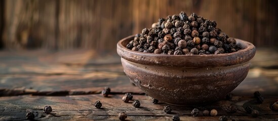 Poster - Clay bowl filled with black pepper on wooden backdrop with ample copy space image conveying notions of healthy eating ayurveda and naturopathy