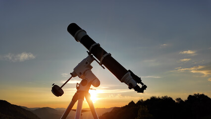 Wall Mural - Preparing for night sky observing with a astronomical telescope just before sunset.