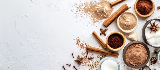 Poster - Baking and dessert essentials like cinnamon cocoa sugar and spices displayed in a top view white background copy space image