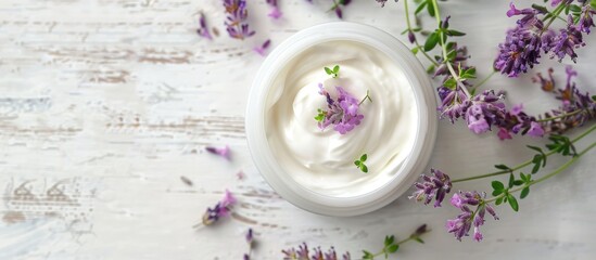 Poster - Cosmetic cream with lavender and thyme leaves on a white wood table with copy space image