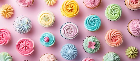 Aufkleber - Colorful cupcakes adorned with sugar paste and cream are displayed as artistic creations at a party captured in a flat lay top view copy space image