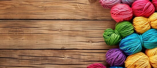 Poster - Bright wooden background with copy space image featuring multicolored decorative yarns