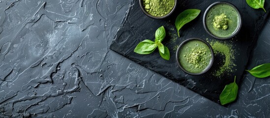 Poster - Composition featuring green matcha powder and a drink on a black table with room for text in the image. Creative banner. Copyspace image