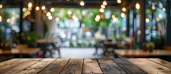 Poster - Blurry background in a cafe or coffee shop setting featuring a wooden table with bokeh effect perfect as a copy space image for showcasing products