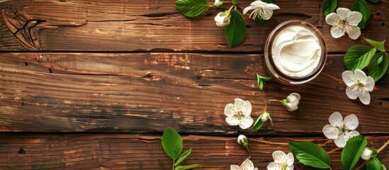 Poster - Bright wooden table with white cosmetic cream and leaf buds offers copy space image