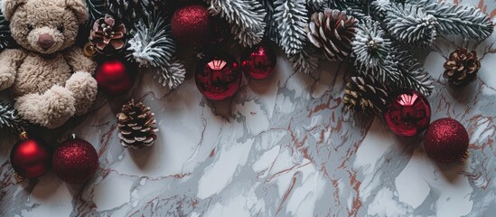 Sticker - Christmas themed flat lay with a festive arrangement of pine cones red baubles and a teddy bear on a marbled background creating a cozy holiday copy space image