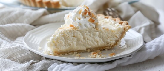 Poster - Coconut cream pie displayed on a white plate with a light cloth napkin underneath in a setting suitable for a copy space image