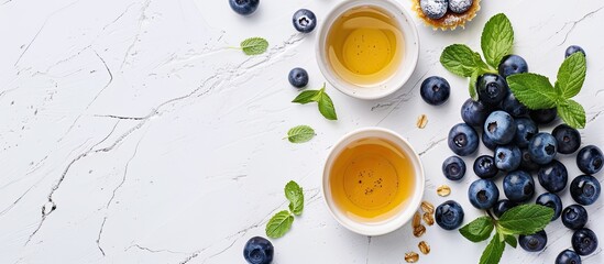 Poster - Blueberry tarts ingredients arranged on a white background for a minimalistic copy space image