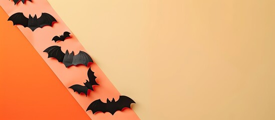 Poster - Colorful Halloween bat ornaments arranged on an orange light pink and beige background with empty space for text. Creative banner. Copyspace image