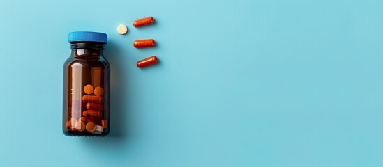 Aufkleber - Top view of a bottle and vitamin capsules displayed against a blue backdrop with copy space image